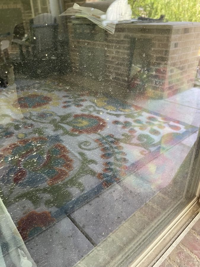 Decorative window before cleaning — water spots and smears