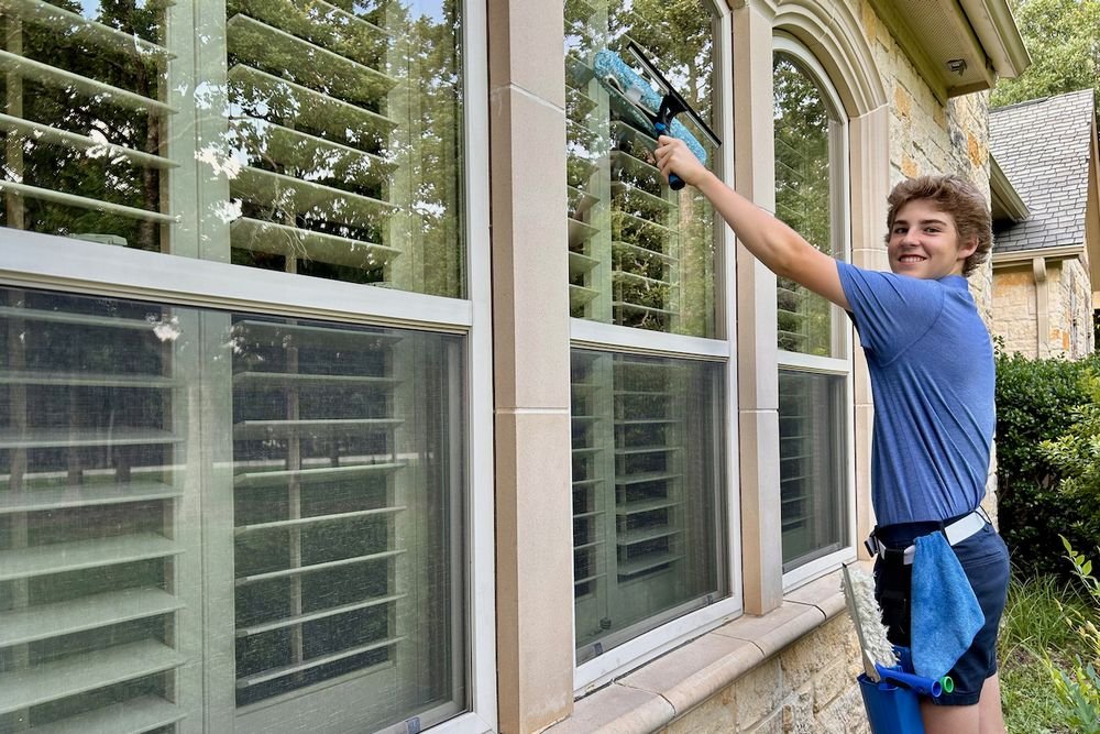 Professional window cleaner at work